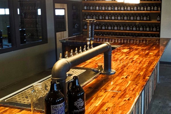 A large, beautiful commercial wooden bar top with an UltraClear Bar & Table Top Epoxy finish.