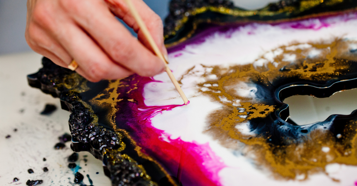 Epoxy resin art being delicately etched with a small wooden pick