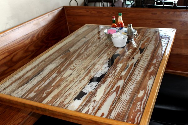 A restaurant table with an UltraClear Bar & Table Top Epoxy finish. It's crystal clear and perfectly smooth for easy maintenance and a clean look.