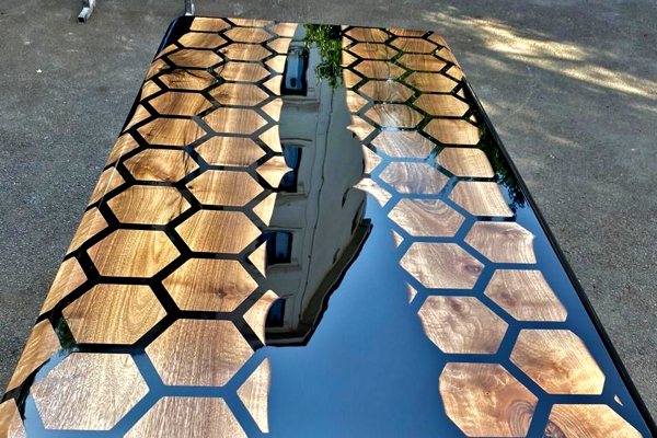 A beautiful epoxy river table made using UltraClear Deep Pour Epoxy to produce a black-tinted river vein and UltraClear Bar & Table Top Epoxy as a transparent topcoat.