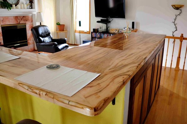 A large L-shaped wooden epoxy countertop with an UltraClear Bar & Table Top Epoxy finish. It is flawless and has no cracks.