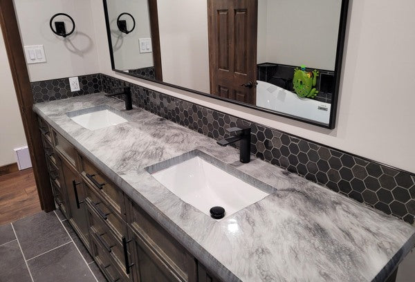 An cured/dried epoxy resin bathroom countertop with two sinks.