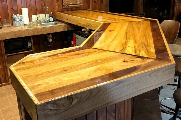A wooden DIY home epoxy bar top with an UltraClear Bar & Table Top Epoxy finish.