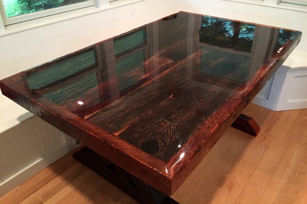 A large wooden dining table with an UltraClear Bar & Table Top Epoxy finish.