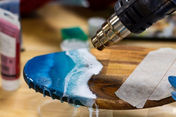 A heat gun being used to manipulate epoxy and remove air bubbles.
