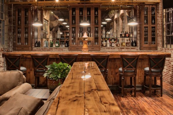 A wooden console table and bar top in a lodge. Both have been finished with an UltraClear Bar & Table Top Epoxy coating.