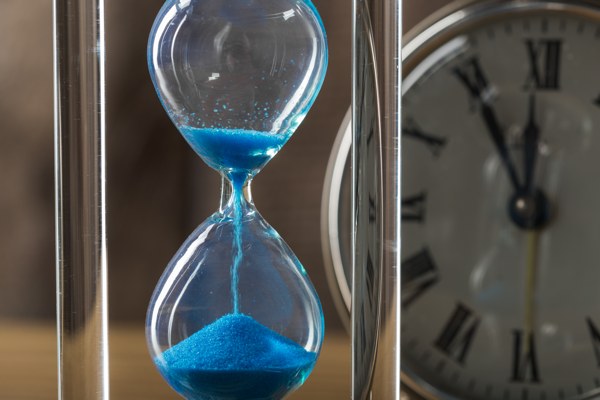 An hourglass filled with flowing sand to represent the passage of time.