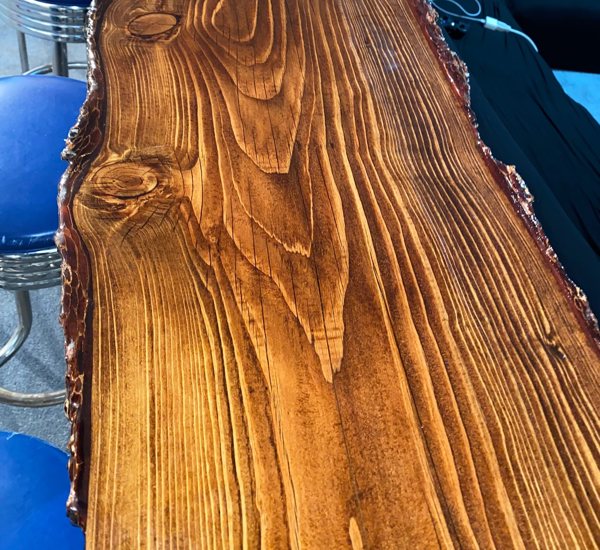 A live-edge wooden epoxy bar top, seen up close.