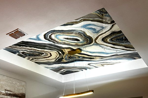 An elaborate work of UltraClear Art & Craft Epoxy geode art embedded into the ceiling of the owner's living room. It features a variety of epoxy veins in different colors along with crystals and metal.