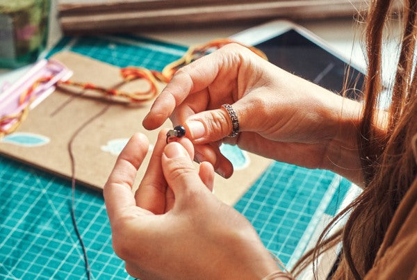 A person making resin jewelry