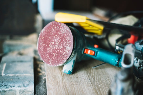 An orbital sander resting on a table