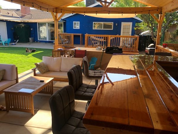 An outdoor epoxy bar top with a wooden shelter.