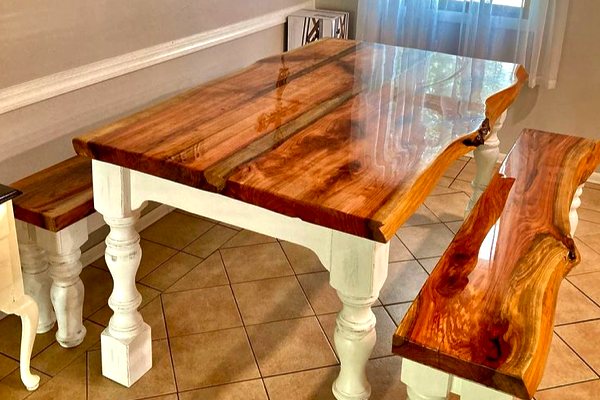 A set of epoxy furniture consisting of a wooden epoxy dining table and two wooden epoxy benches. They've all been finished with UltraClear Bar & Table Top Epoxy.
