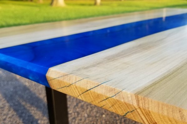 A river epoxy coffee table with an opaque blue-tinted river vein of UltraClear Deep Pour Epoxy.