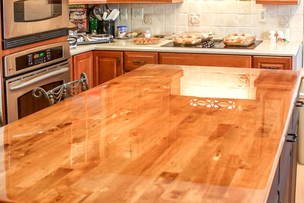 A wooden kitchen island with an UltraClear Bar & Table Top Epoxy finish.