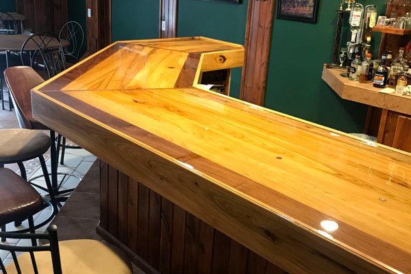 A wooden DIY home bar top with an epoxy finish.