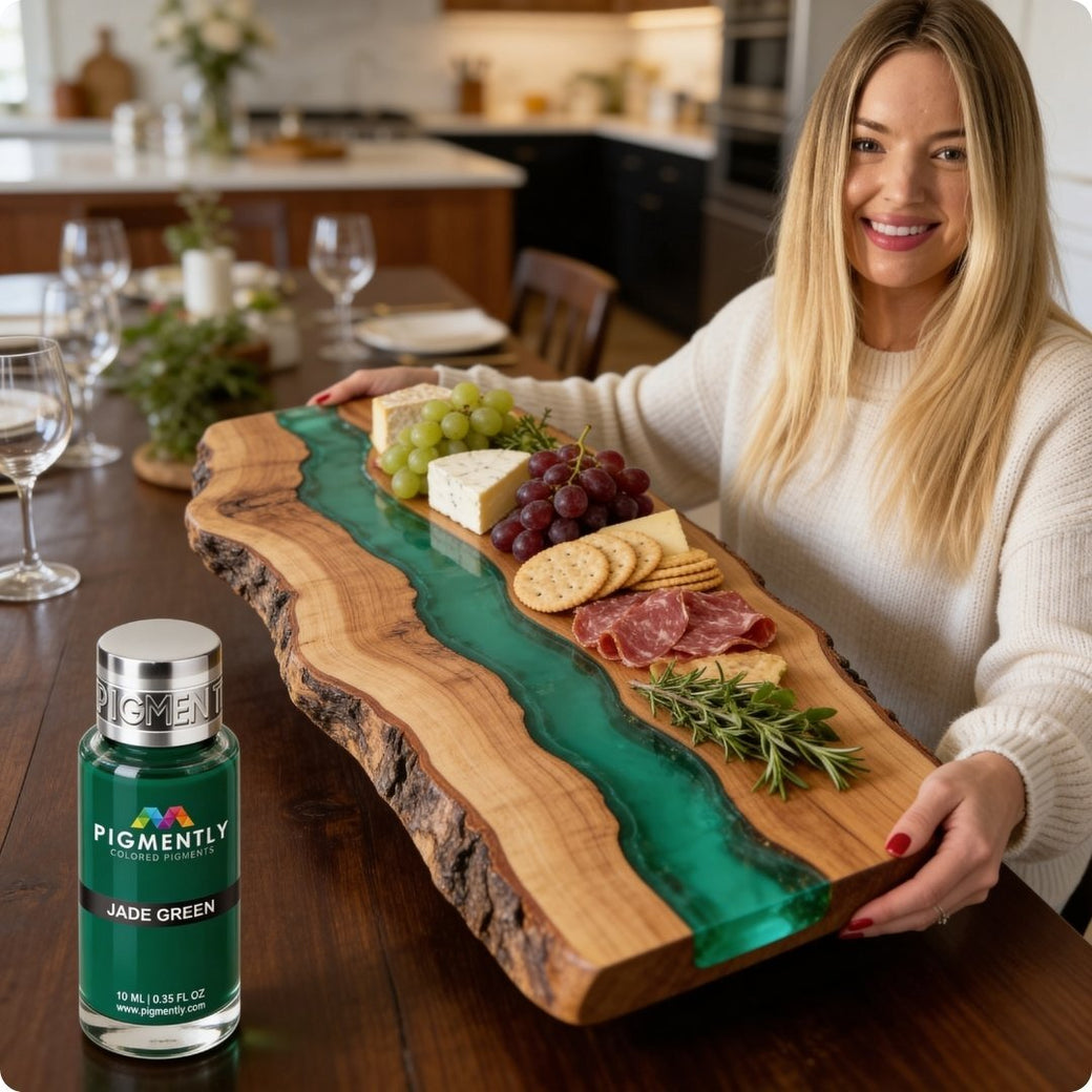 Ilona holding a wooden charcuterie board with food, next to a bottle of Pigmently jade green paint.