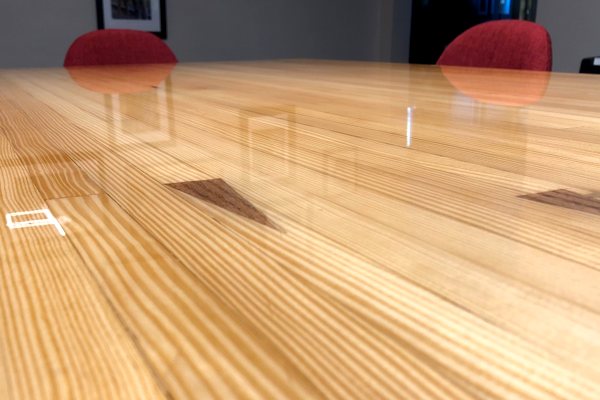 A close-up view of an epoxy table top with an UltraClear Bar & Table Top Epoxy finish. The epoxy surface is perfectly smooth and clear.