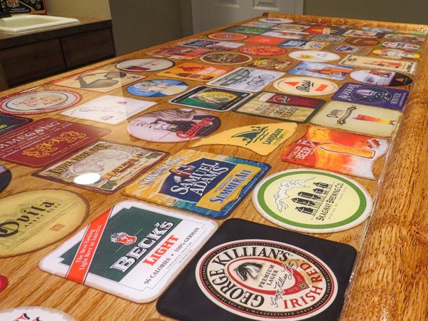 A close-up view of a wooden epoxy bar top with a variety of embedments.