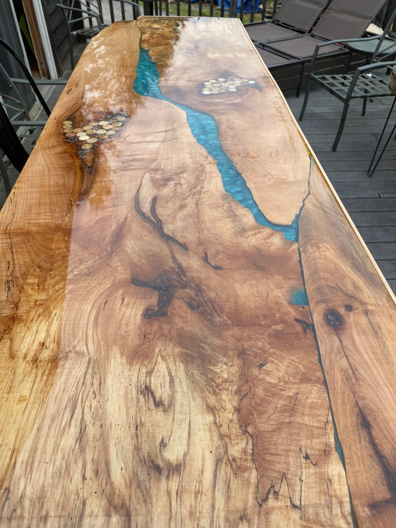 A wooden epoxy river table
