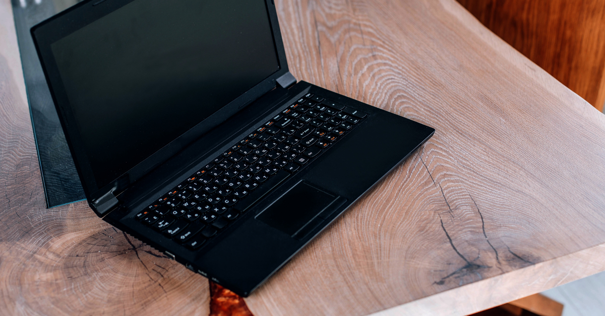A laptop on an unfinished wooden slab
