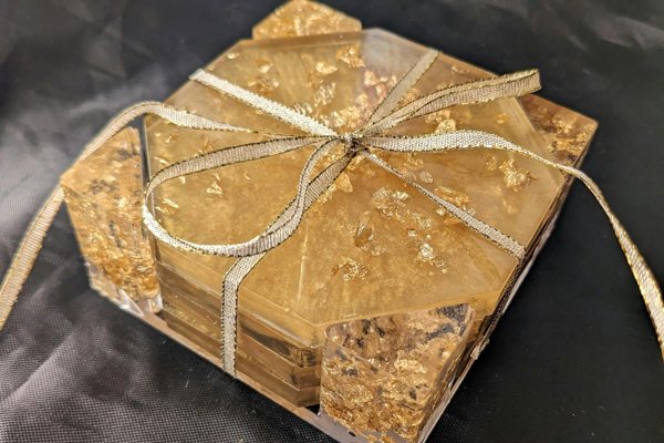 A set of custom epoxy coasters and a matching holder made using UltraClear Art & Craft Epoxy along with powder pigments anad gold flakes.