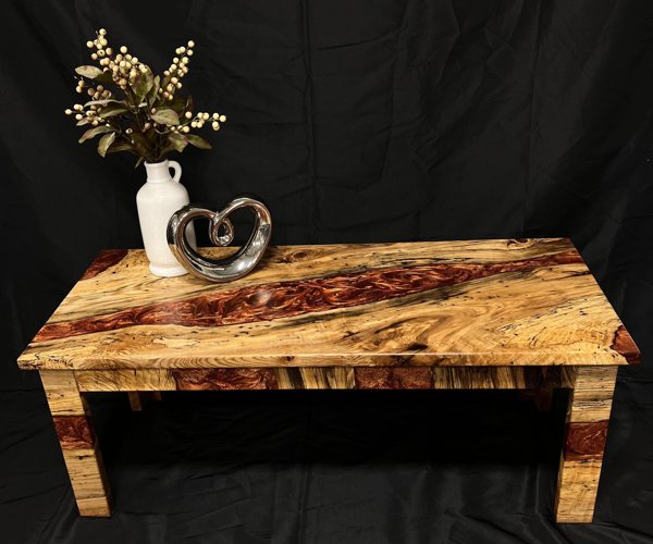 A wooden epoxy river table made using UltraClear Deep Pour Epoxy and red epoxy pigments.