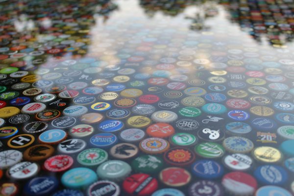 A closeup view of an epoxy bottlecap table top, made using UltraClear Table Top Epoxy.