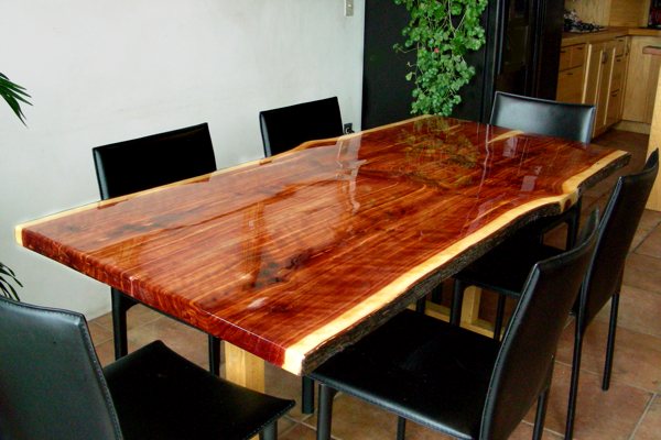A live-edge wooden epoxy dining table. The table top has been sealed with UltraClear Bar & Table Top Epoxy.