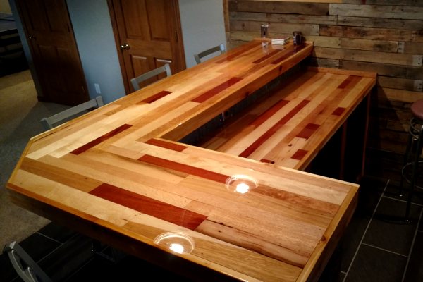 A wooden DIY home bar top with an UltraClear Bar & Table Top Epoxy coating.