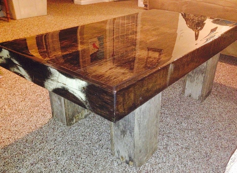 A block table with a table top epoxy flood coat