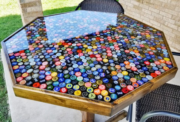 An epoxy bottle cap table top, placed outdoors.