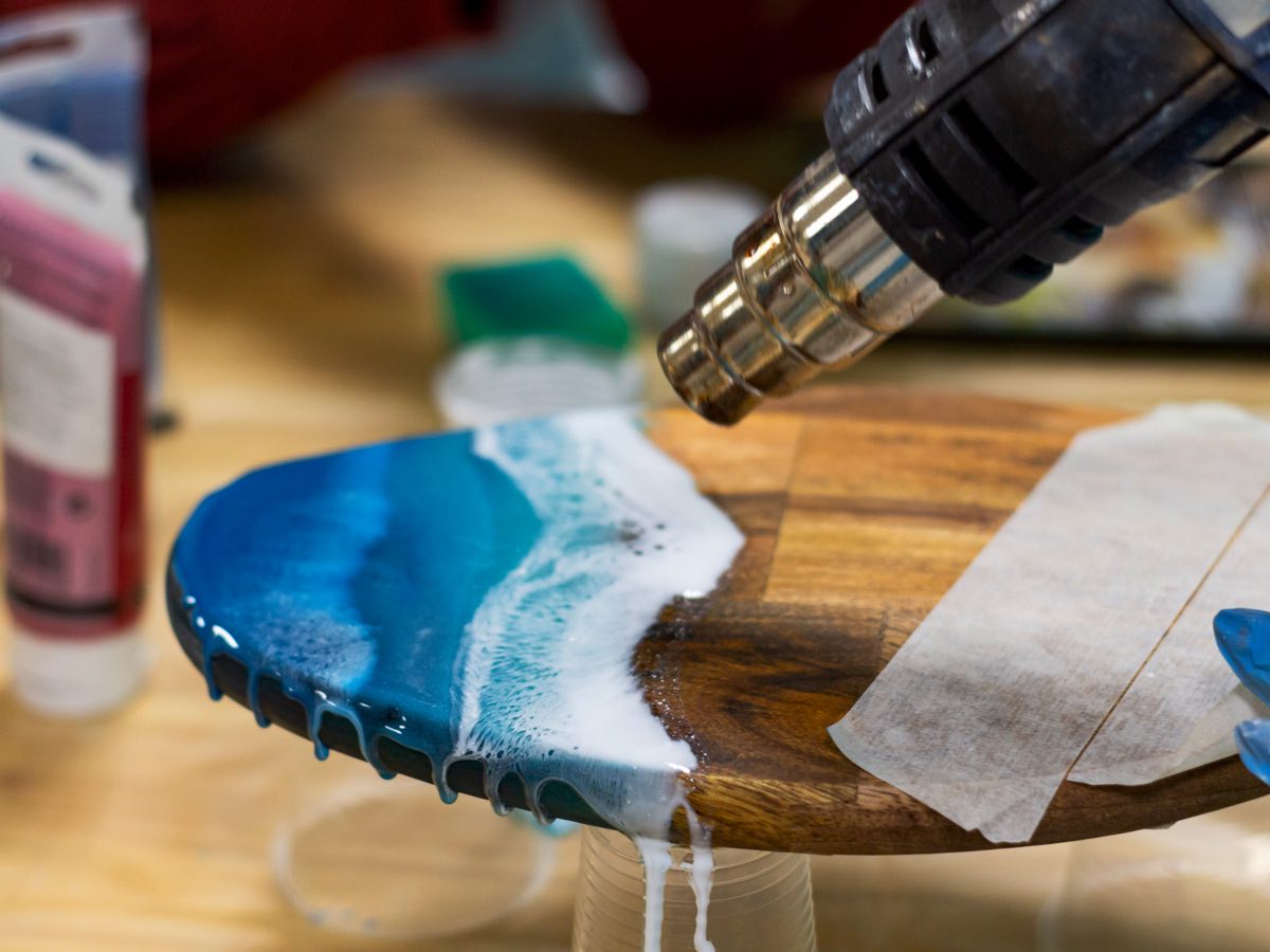 A heat gun being used on an epoxy coating to remove air bubbles