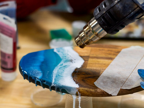 A heat gun being used on an epoxy coating to remove air bubbles