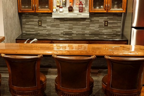 A DIY wooden bar top with an UltraClear Bar & Table Top Epoxy finish for a smooth, high-gloss surface and a highly protective seal.
