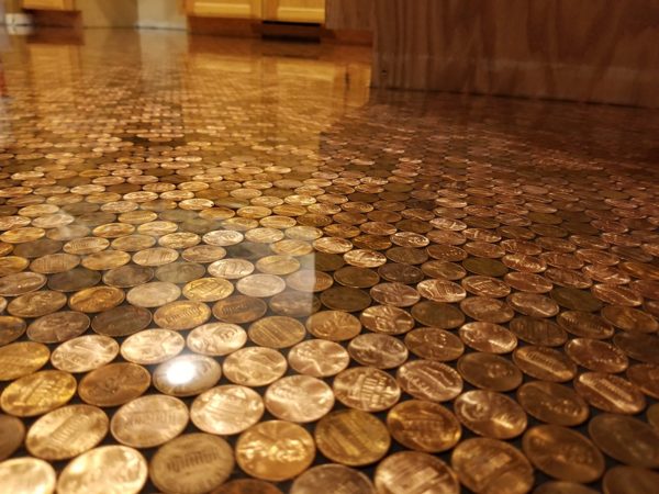 A close up view of an epoxy penny bathroom floor