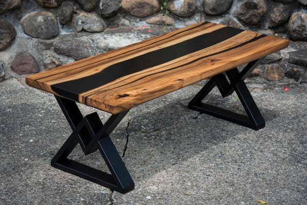 An epoxy river table with a black pigmented epoxy vein