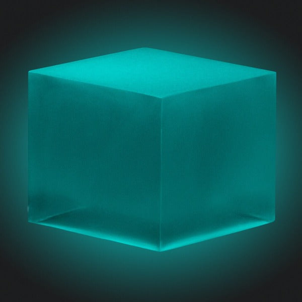 A sample epoxy resin cube made using epoxy and Blue-Green Glow in the Dark Resin Pigment from Pigmently