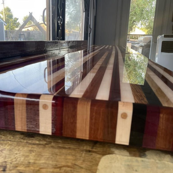 A long wooden bar top with a clean coating of bar top epoxy.