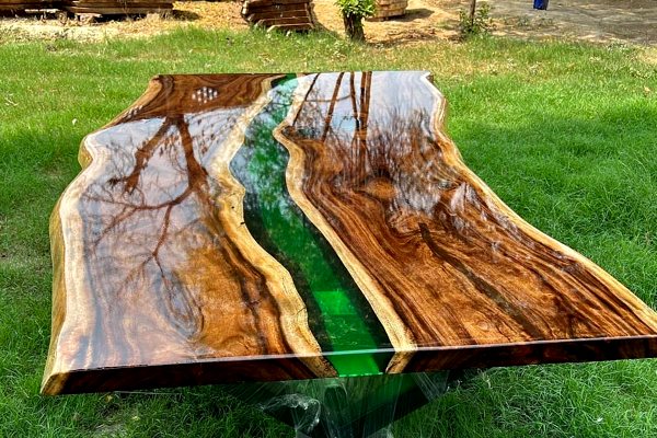 An epoxy river table with a translucenrt green UltraClear Deep Pour Epoxy river vein and a clear topcoat of UltraClear Bar & Table Top Epoxy