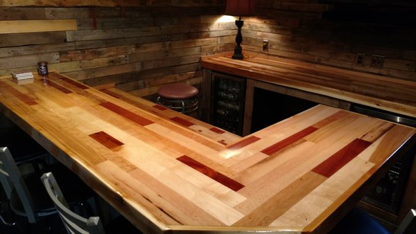 A large wooden epoxy butcher block countertop in a dimly lit room.