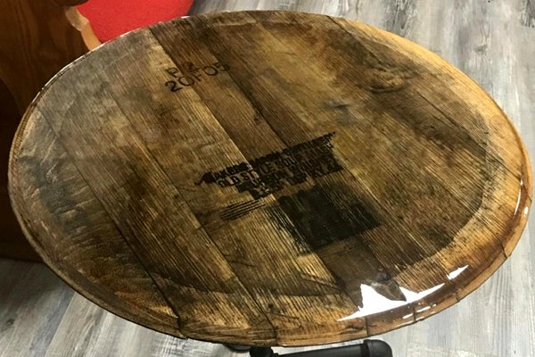 A wooden epoxy end tabel with a rustic design, made using an old barrel top and UltraClear Bar & Table Top Epoxy