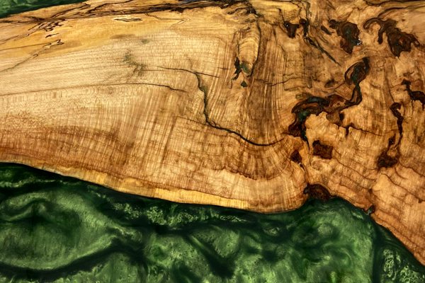 Close-up view of an epoxy river tray with an UltraClear Deep Pour Epoxy river vein that has been pigmented a deep opaque green.