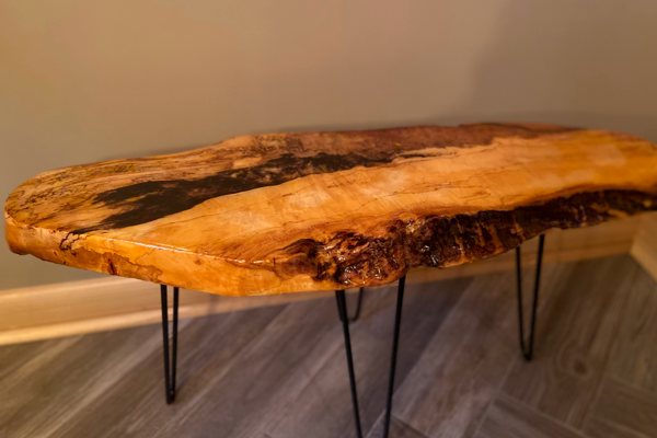 A small live-edge wooden end table with an UltraClear Bar & Table Top Epoxy finish. The epoxy's self-leveling nature has caused it to conform perfectly to the unusual shape of the wooden substrate.