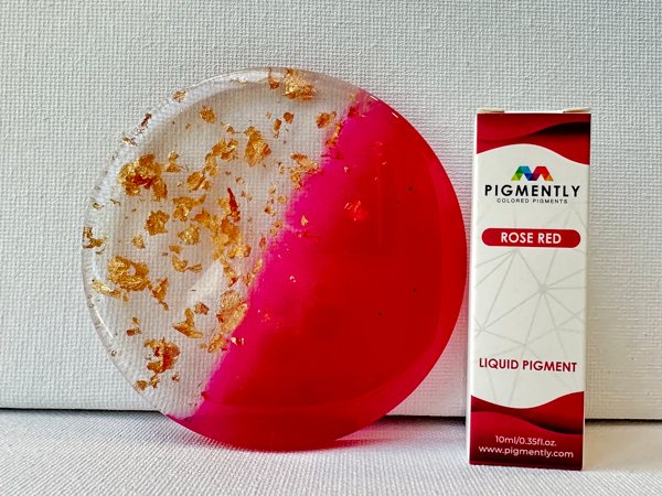 An epoxy resin art piee made with epoxy, shiny metallic flakes, and Rose Red Epoxy Dye from Pigmently
