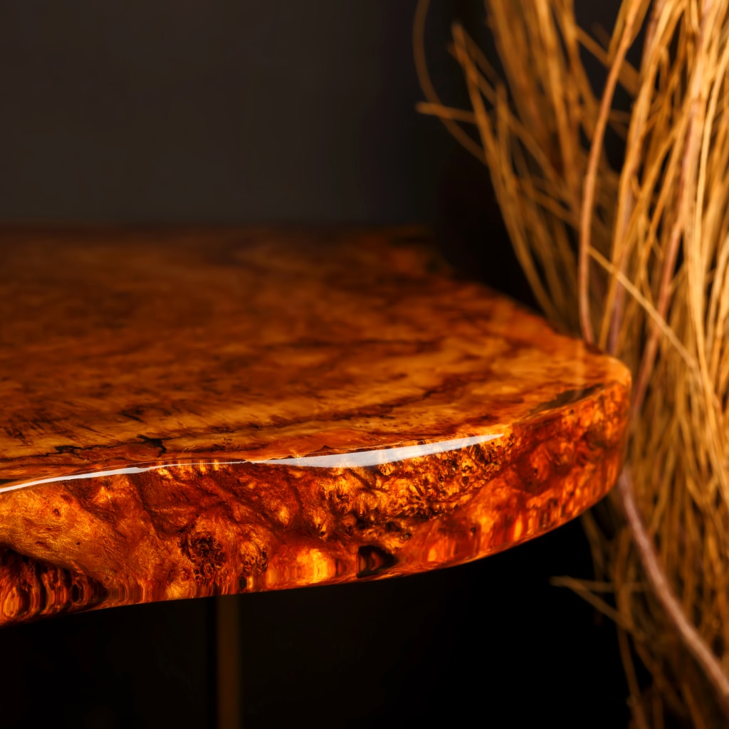 Round epoxy wooden table with a textured surface on a dark background