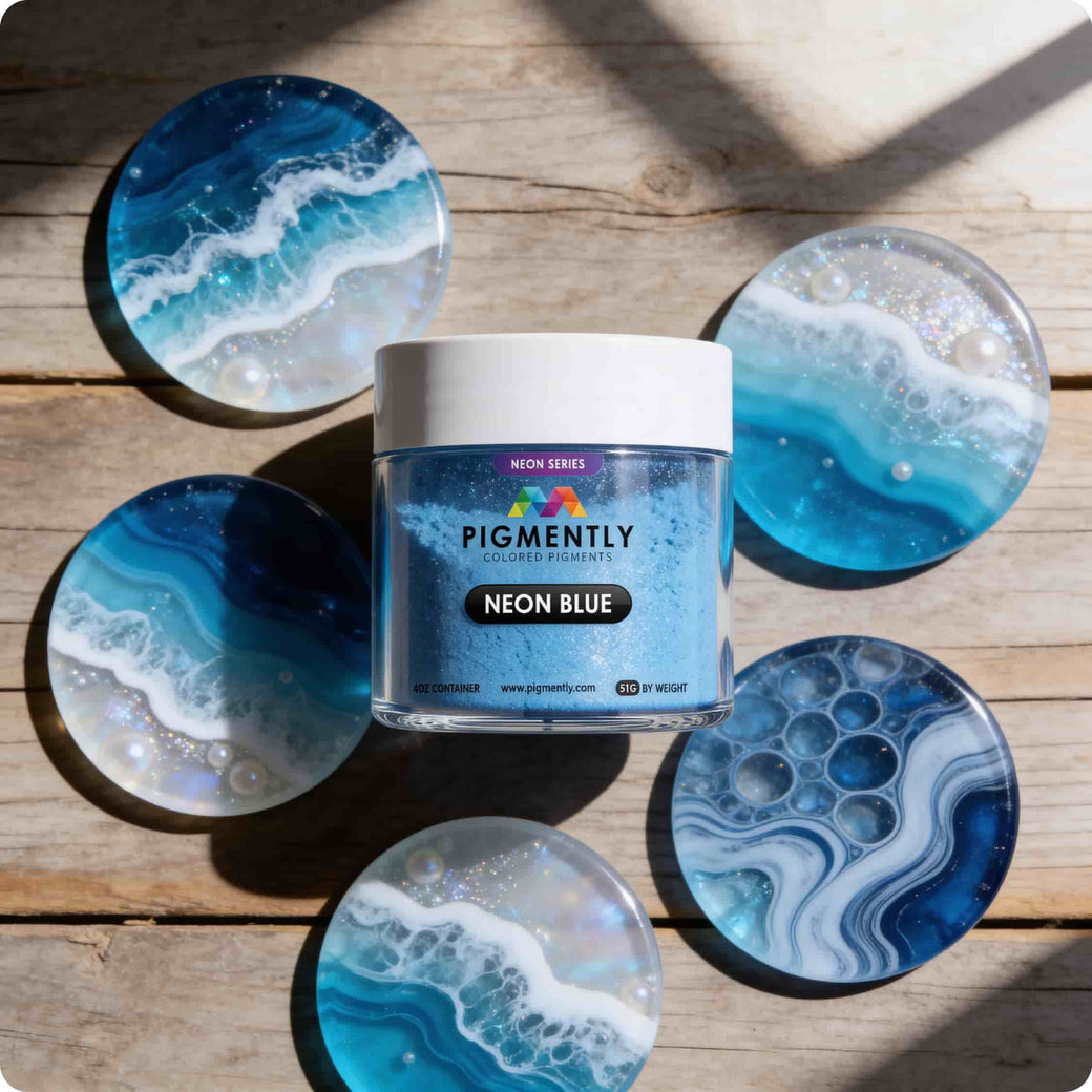 Neon blue powder pigment container with marbled blue and white coasters on a wooden surface